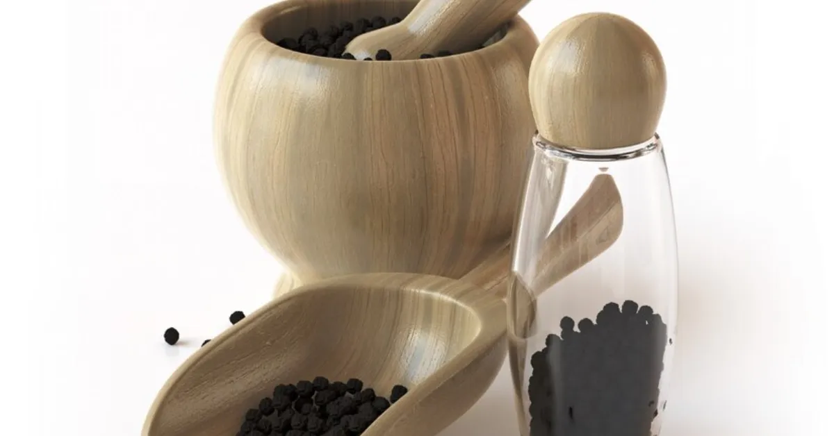wooden tableware with black pepper seeds