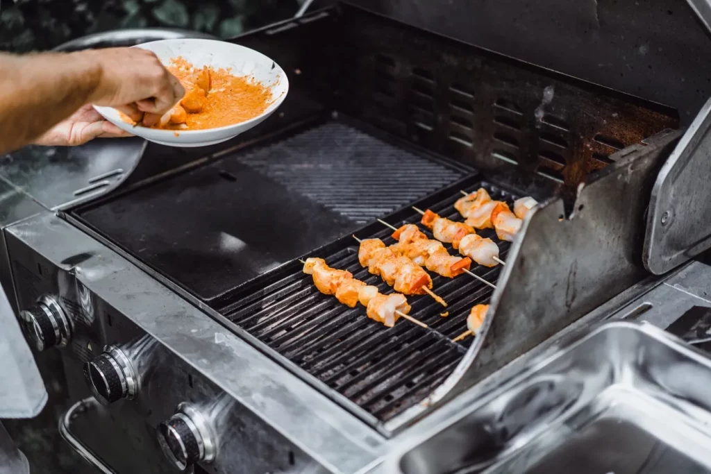 A person cooking food on a Blackstone Griddle.