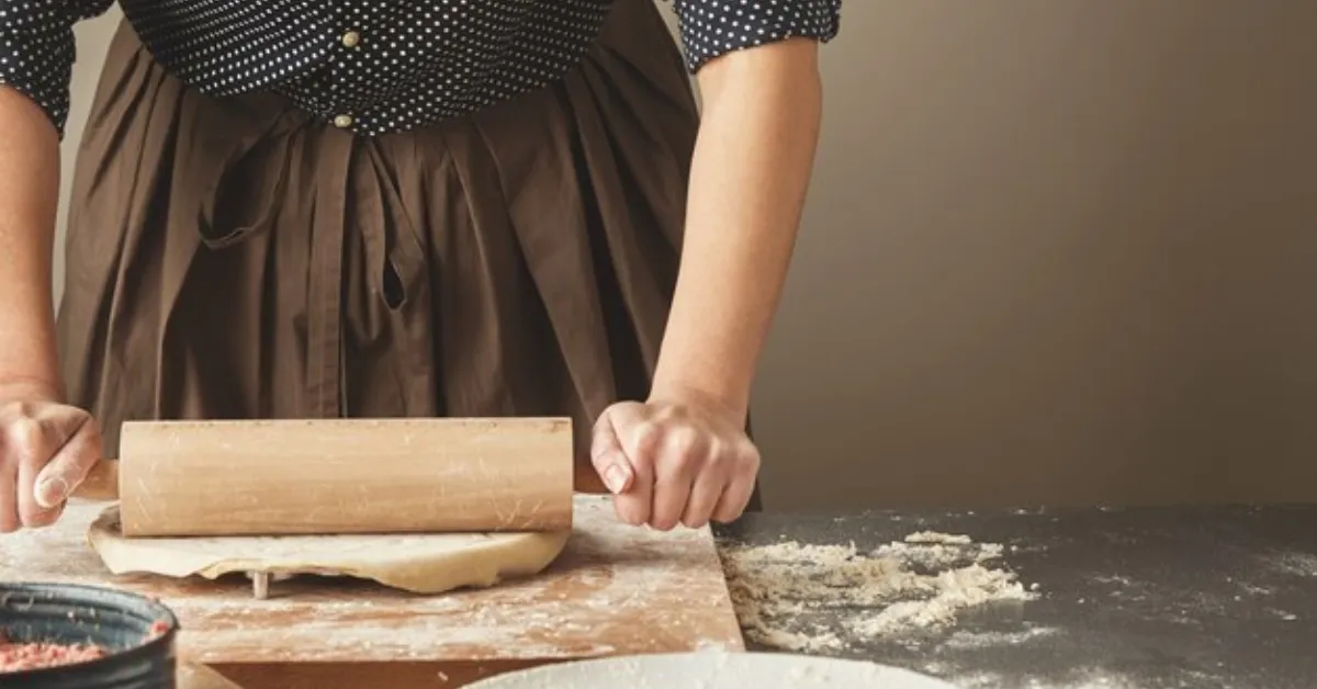 woman baking using flour which is the main primary component in cake