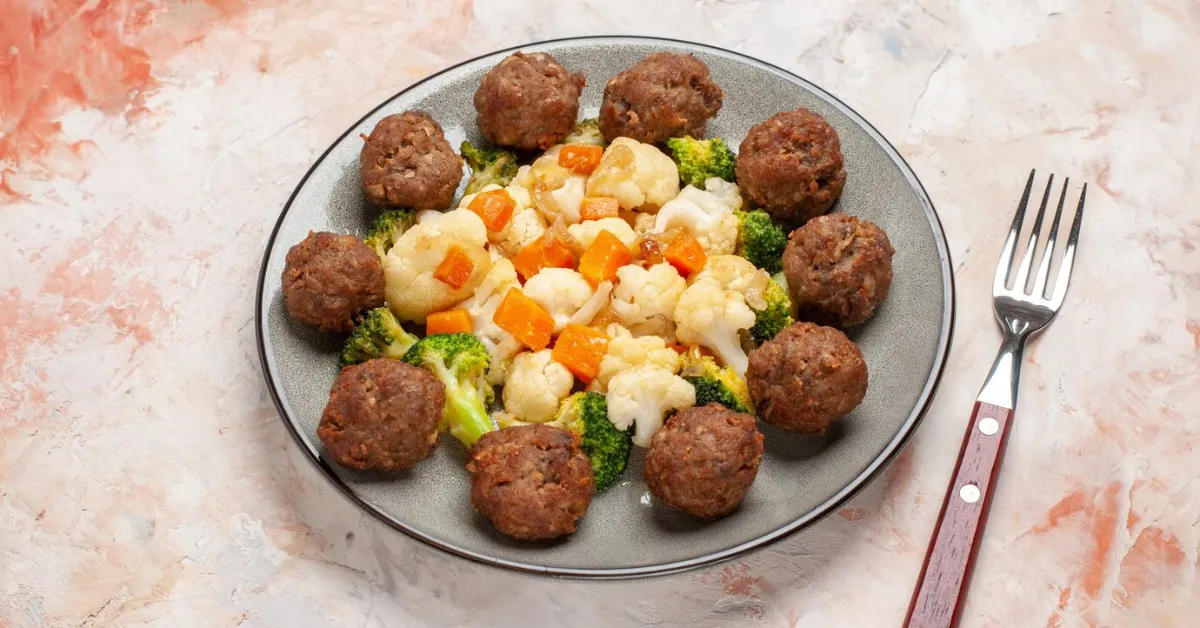 fried meatballs in a plate with broccoli and cauliflower salad