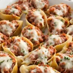 San Giorgio stuffed shells with meat, a traditional Italian dish made with large pasta shells filled with a mixture of ground meat, vegetables, and cheese.