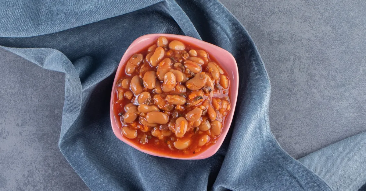 Bowl of baked beans on a blue cloth