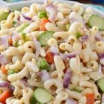 A bowl of Zippy's macaroni salad from Hawaii, made with macaroni noodles, onions, carrots, cucumbers, and a creamy mayonnaise dressing.